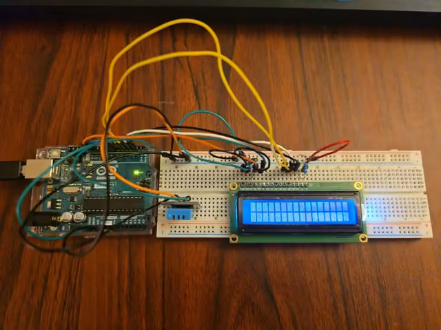 Arduino Uno wired to a breadboard with an LCD display and a temperature sensor
