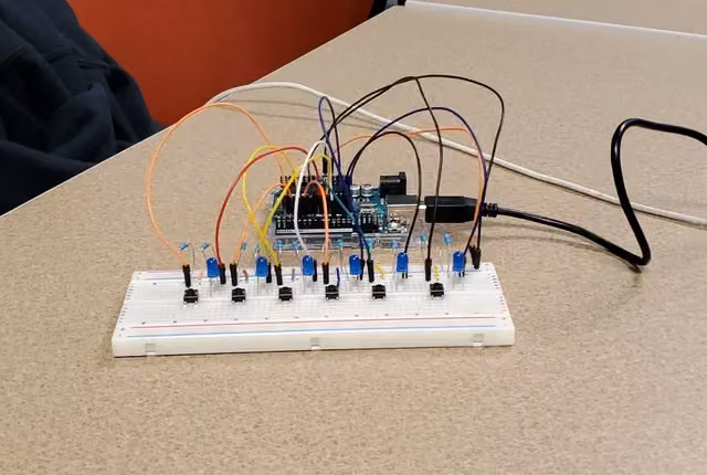 Arduino wired to a breadboard full of LEDs and push buttons